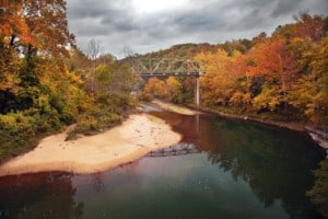 A bridge over the Buffalo River in Arkansas shot in the peak of the Fall season