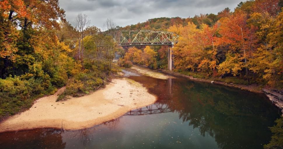 A bridge over the Buffalo River in Arkansas shot in the peak of the Fall season