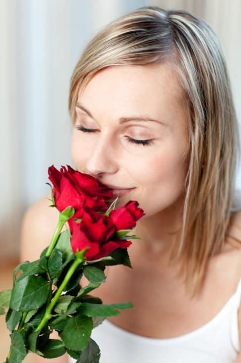 Woman smelling roses