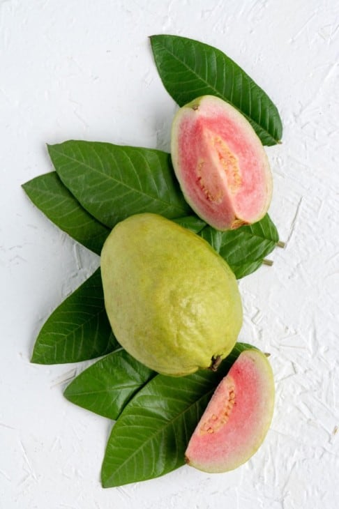 Whole and cut red guava